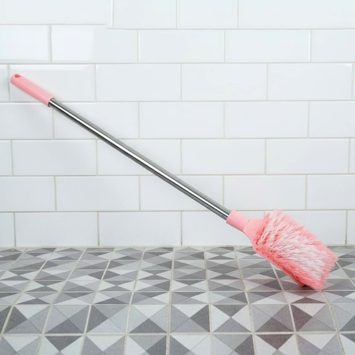 Angled shot of long handle toilet cleaning brush designed for bathroom use