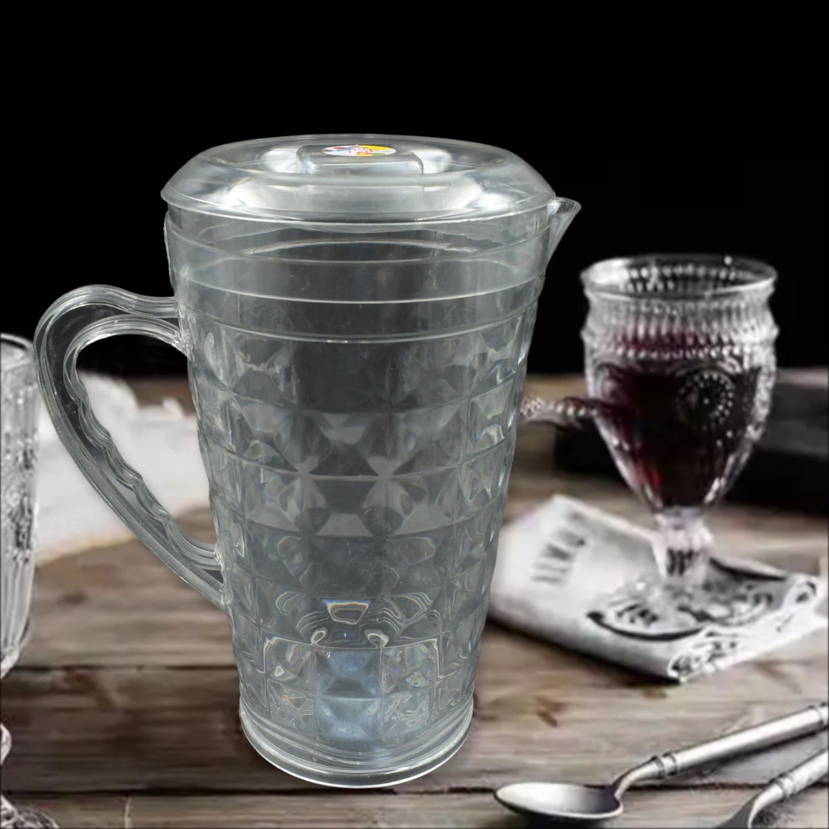 Angled view of the Mocktail PET Plastic Jug, highlighting its elegant diamond-cut design and clear material.