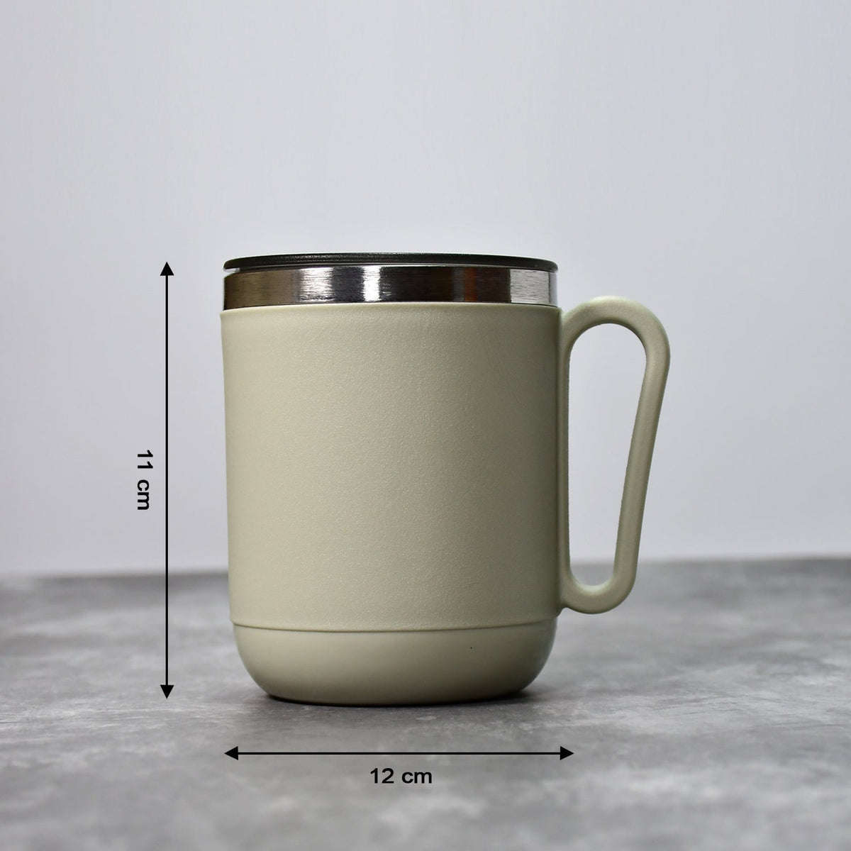 An Indian man enjoying a hot beverage from the Ganesh stainless steel coffee mug.