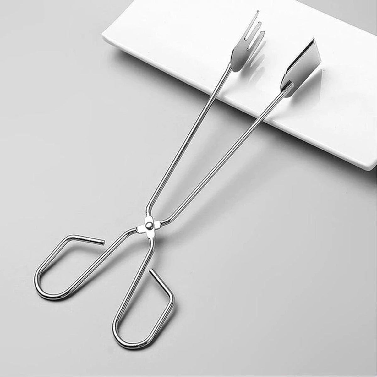 Food serving tong with threaded tips for secure grip at parties.