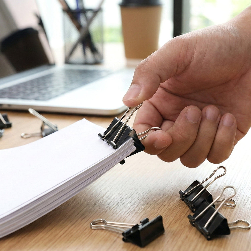 Black binder clips gripping important documents firmly