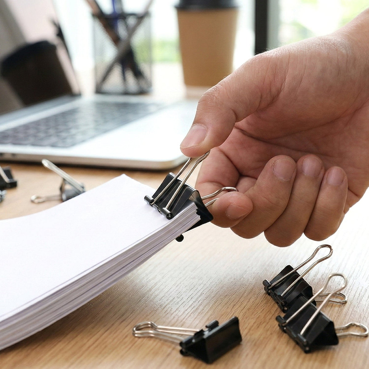 Black binder clips gripping important documents firmly