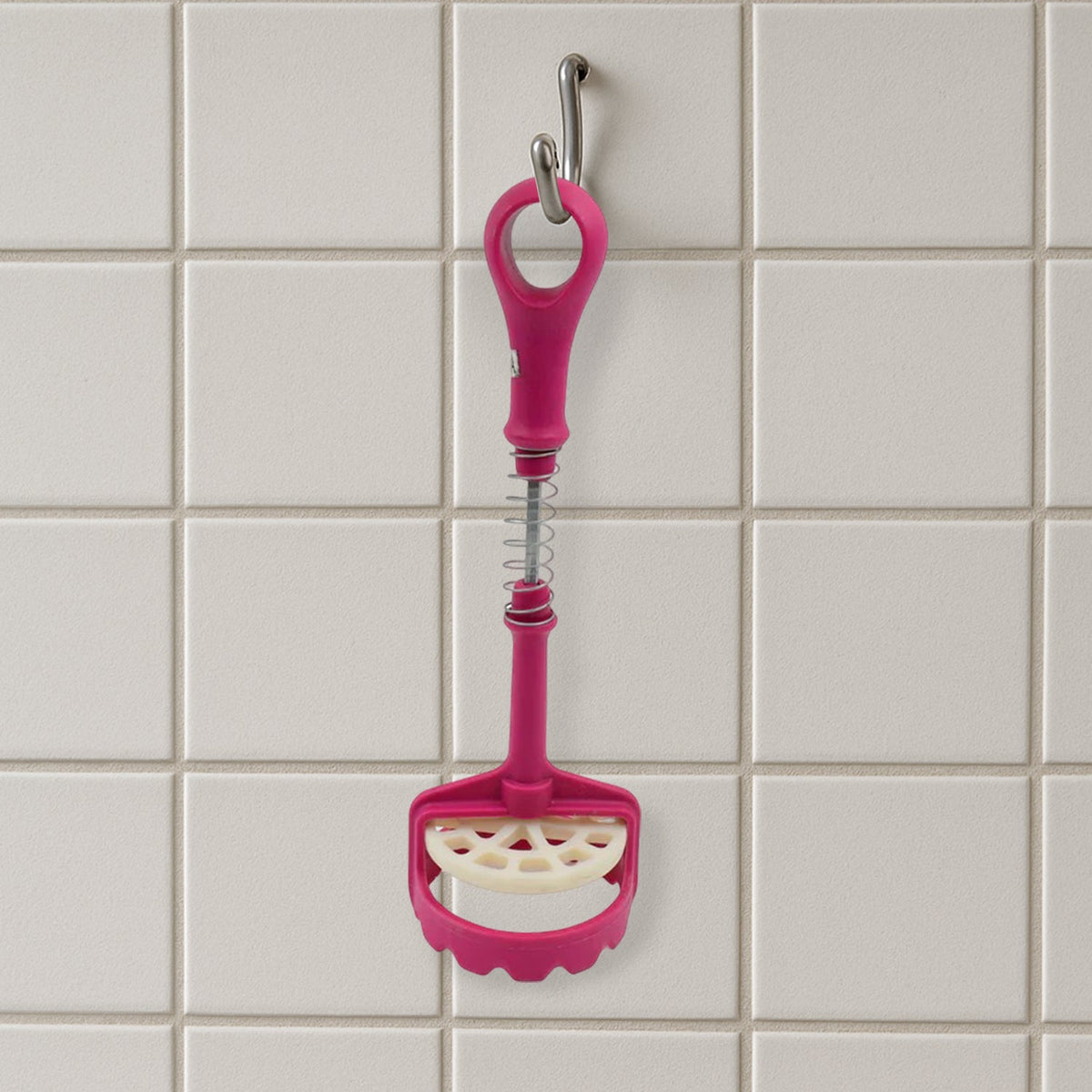 Easy-to-clean food-grade potato masher under running water.