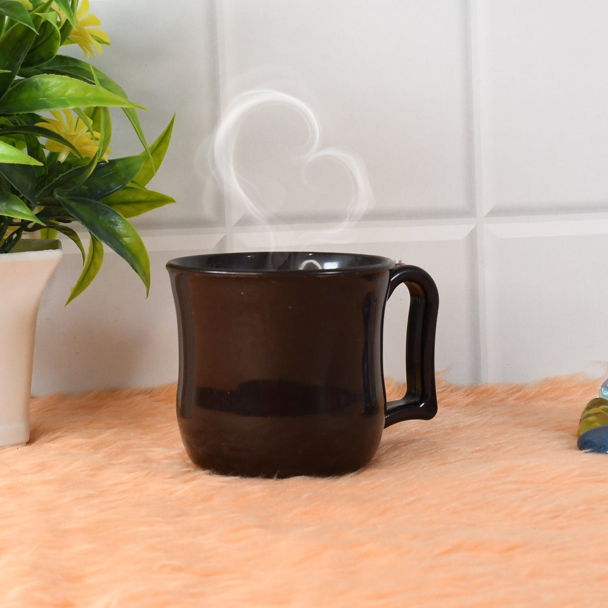 Stack of three black plastic coffee mugs, showcasing their space-saving design.