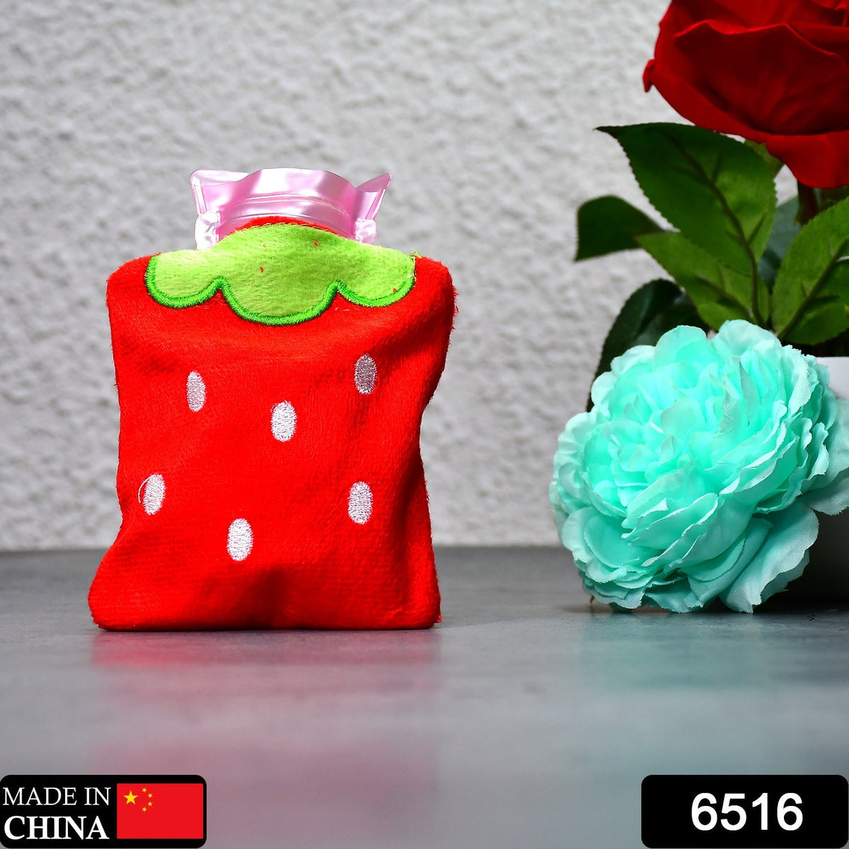 Cute strawberry hot water bag on a white background, ready for use.
