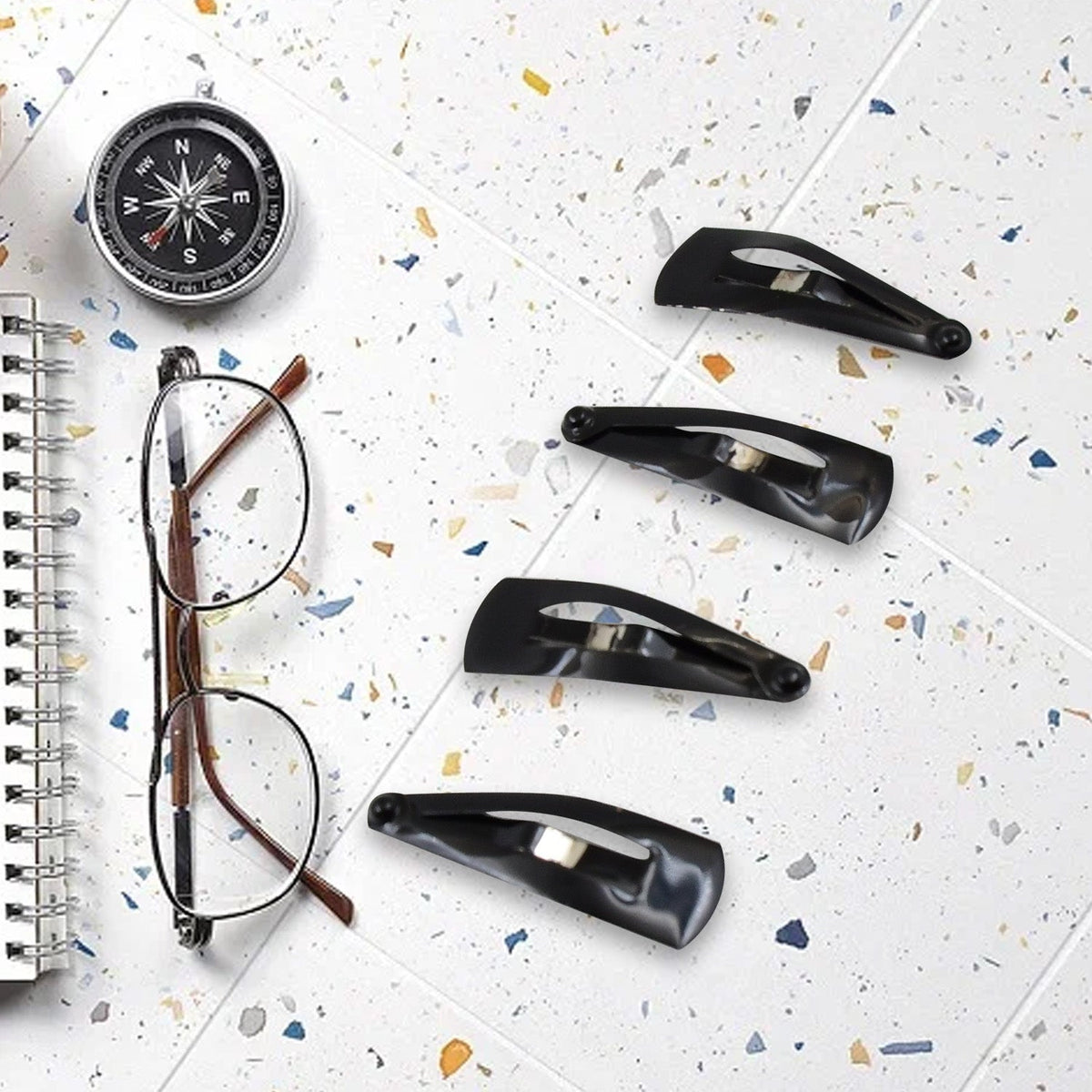 Matt black Metal Tic Tac Hair Clips on a neutral background, showcasing their sleek design.