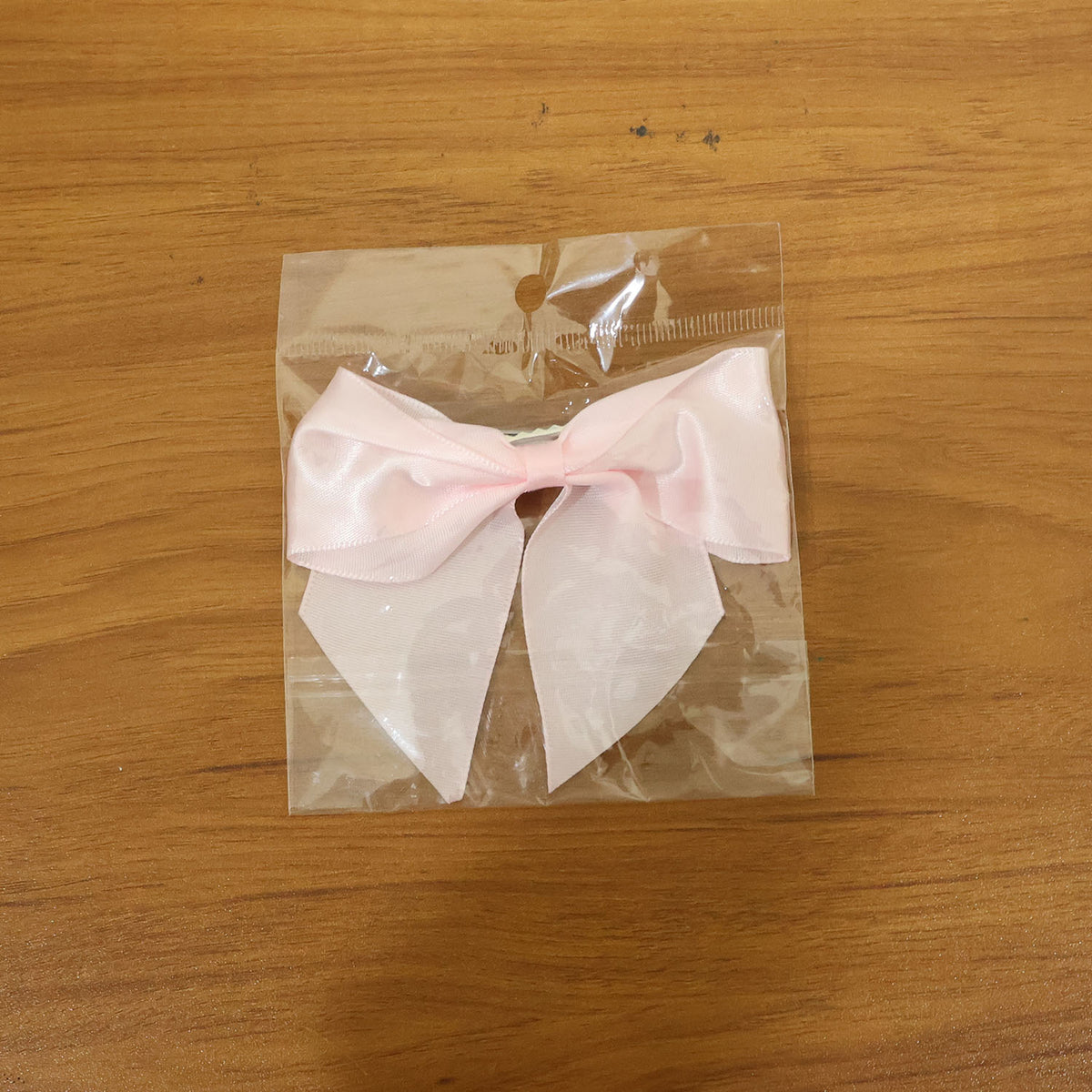 Model wearing satin hair bow clip showcasing stylish hair accessory