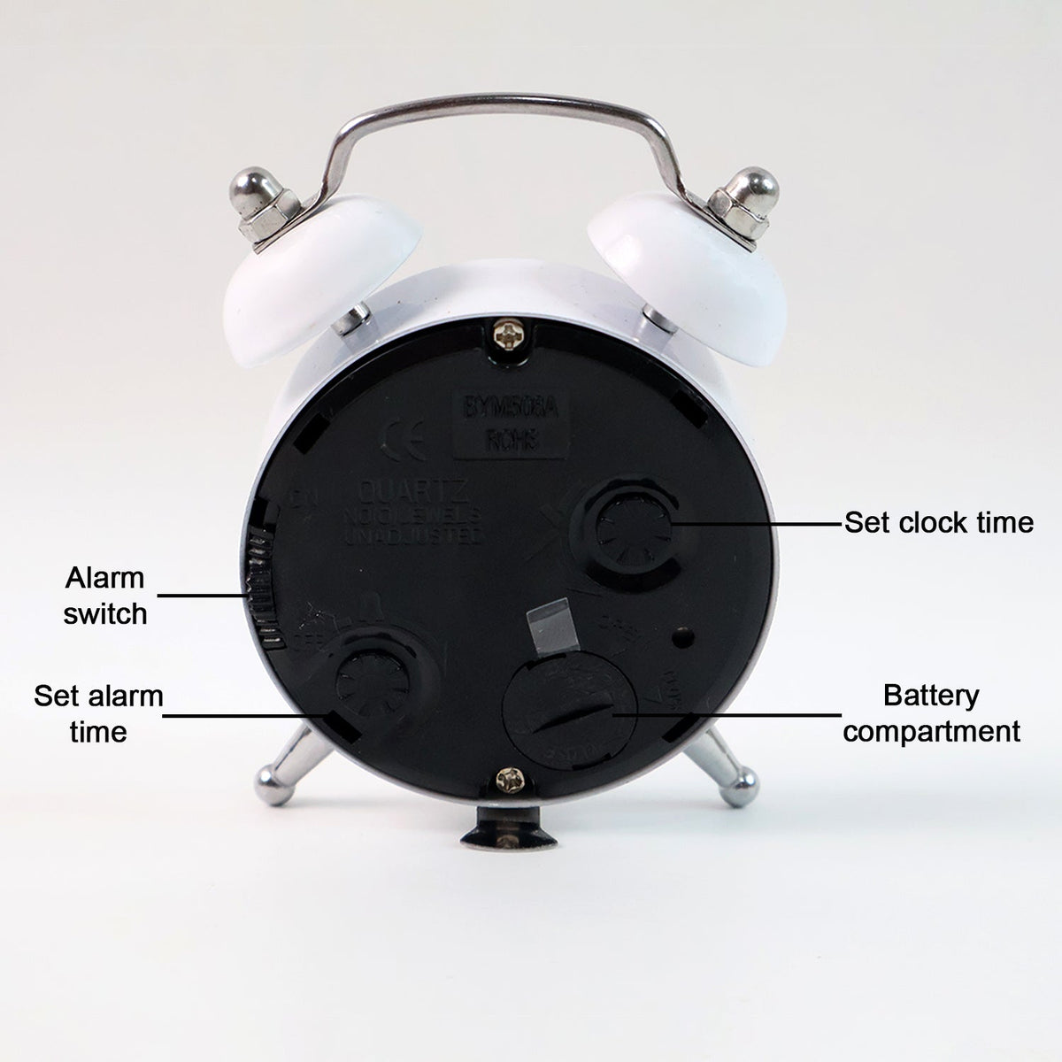 Twin-bell analog alarm clock placed on a modern bedside table.
