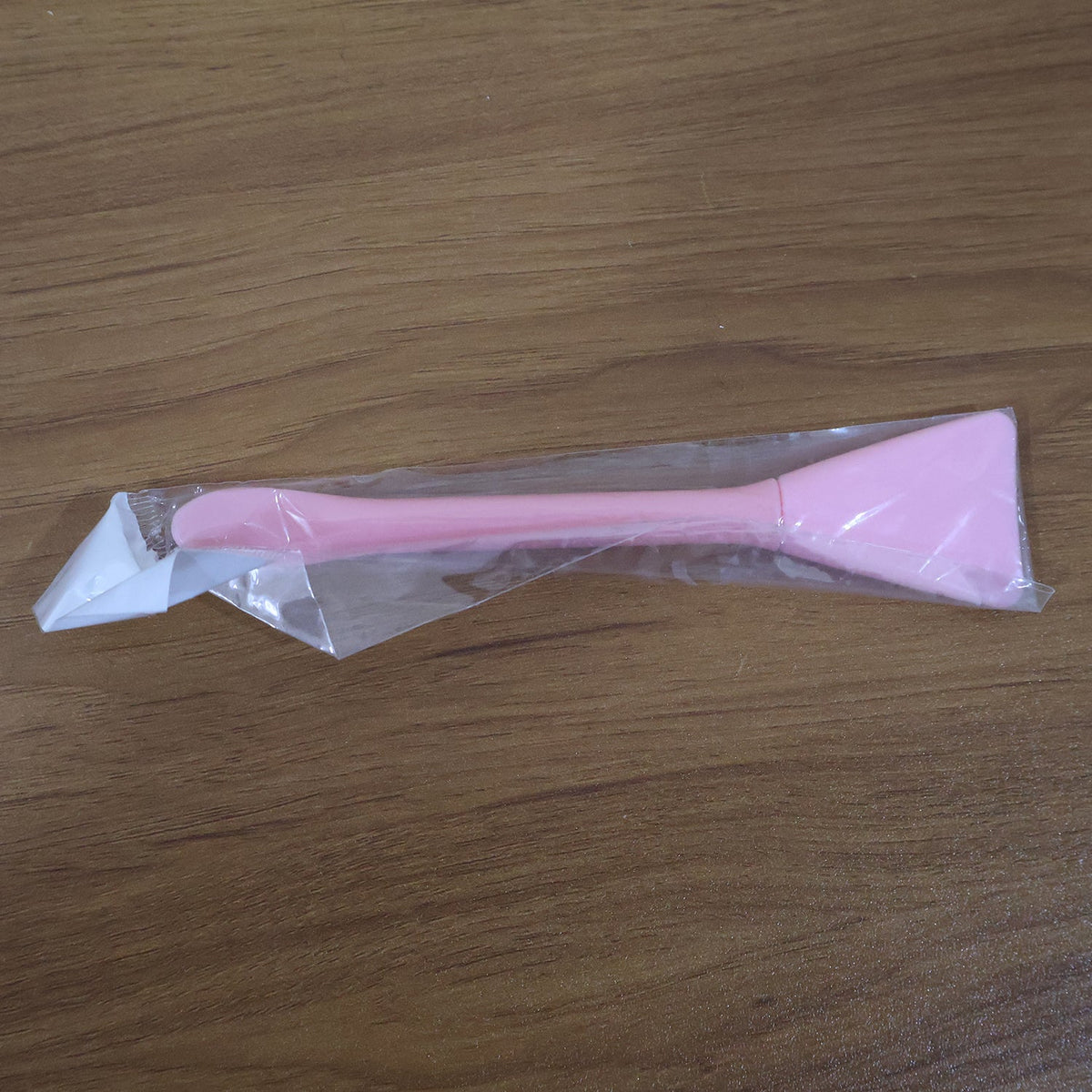 Close-up image of silicone facial mask applicator tool