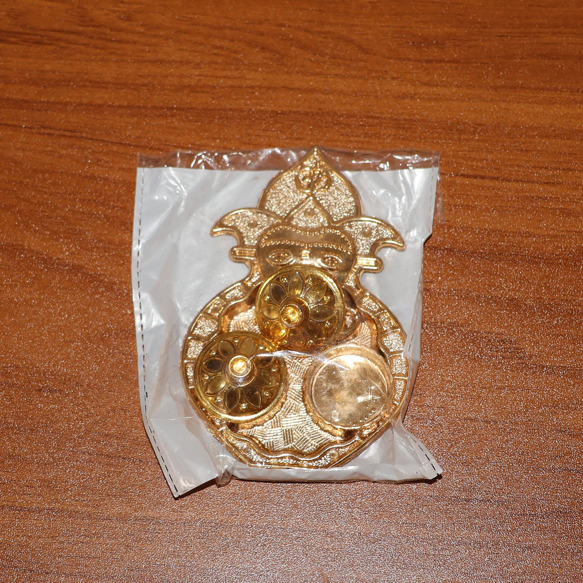 Decorative dual compartment kumkum holder with a golden finish for religious use